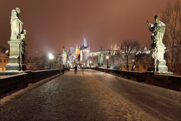 Night snowy Prague Castle with Sculptures from Charles Bridge