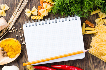 Naklejka na ściany i meble spices and vegetables around notebook