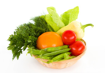 Fresh vegetables in the basket isolated over white