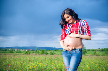 Fototapeta premium Beautiful pregnant woman relaxing outside