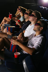 Young people watching movie in cinema