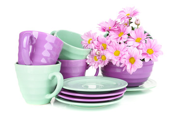 Bright dishes with flowers isolated on white