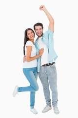 Fototapeta premium Happy casual couple cheering at camera