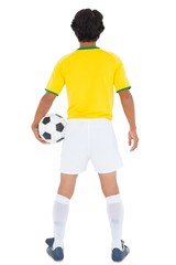 Football player in yellow holding ball