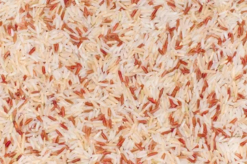 Gordijnen Brown rice grains top view © ployubon