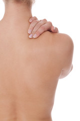 Woman caressing her bare shoulder and back