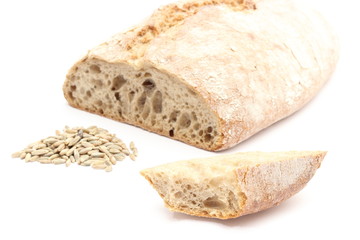 Slice and loaf bread with heap of rye grain