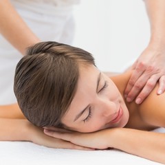 Obraz na płótnie Canvas Attractive woman receiving shoulder massage at spa center