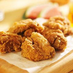 pile of fried chicken with watermelon in background