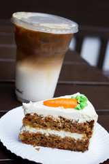 Carrot cake and ice coffee on table
