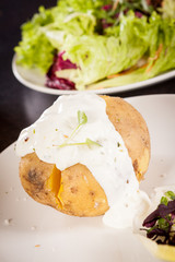 Baked jacket potato with sour cream sauce