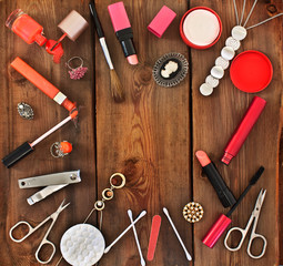Set of cosmetics and women's jewelry on wooden background