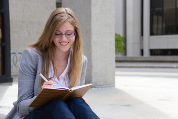 Happy woman writing in her journal