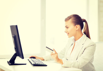 businesswoman with computer using credit card