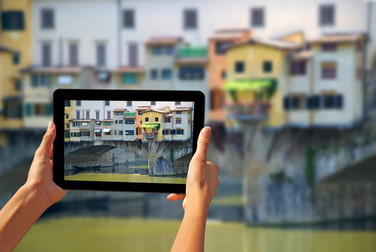 Ponte Vecchio Woman taking pictures on a tablet