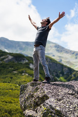 Happy young man in the mountains