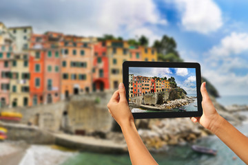 Riomaggiore Woman taking pictures on a tablet