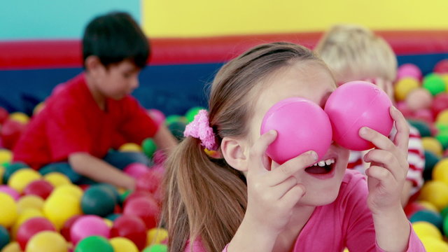 Cute children playing and having fun in the ball pool