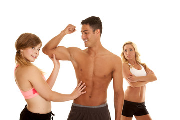 fitness man with two women one mad arms folded