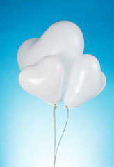 Fototapeta na wymiar Heart shaped white balloons