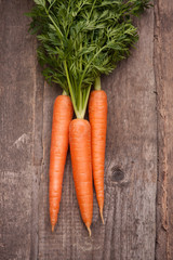 fresh carrot bunch on grungy wooden background