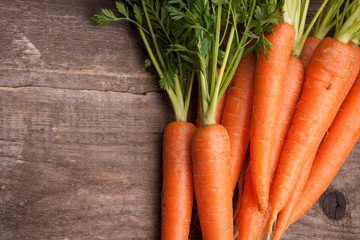 fresh carrot bunch on grungy wooden background