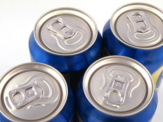 Close up of ring pulls on the tops of drink cans.