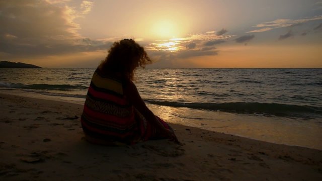 Girl Drawing Heart on a Sand at Sunset. Slow Motion.