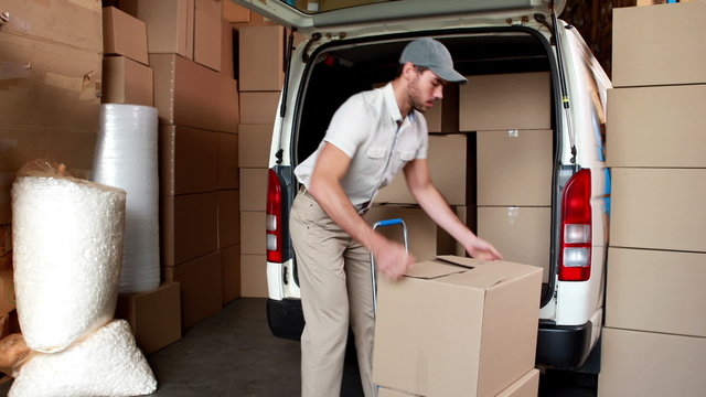 Delivery driver packing his van