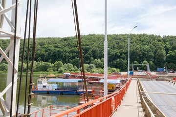 tug boat sets section of the pontoon bridge