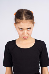 Portrait grumpy unhappy little girl, puffing up her cheeks