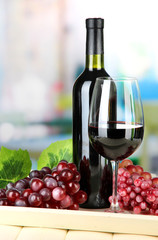 Ripe grapes, bottle and glass of wine
