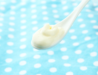 Sour cream in spoon close-up