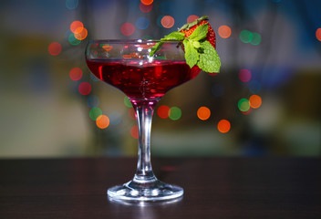 Tasty strawberry cocktail on bright background