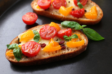 Tasty bruschetta with tomatoes in pan, close up