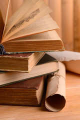 Old books on table on wooden background