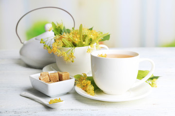 Tasty herbal tea with linden flowers on wooden table