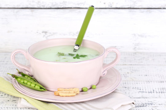 Tasty peas soup on wooden table