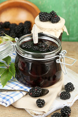 Fototapeta na wymiar Tasty blackberry jam and fresh berries, on wooden table