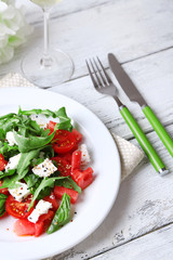 Salad with watermelon, feta, arugula and basil leaves