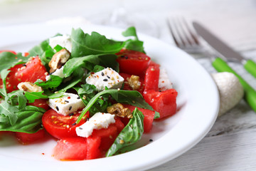 Salad with watermelon, feta, arugula and basil leaves