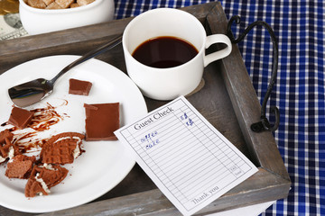 Check and remnants of food and drink on table close-up