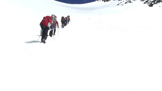 Climbers go up  to the mountain pass