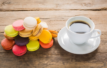 Fototapeta na wymiar French colorful macarons with cup of coffee