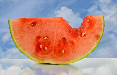 juicy watermelon with sky reflection