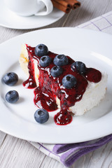 Blueberry cheesecake with berry sauce closeup top view