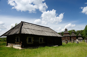 Fototapeta na wymiar Old wooden house and resurrection church from Poltavshina