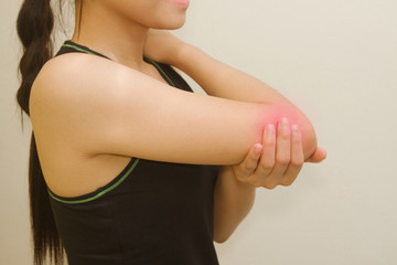 Sports injury ,young woman having pain in her elbow