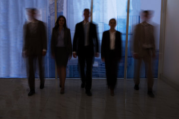 Business People Walking In Office Corridor