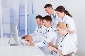 Fototapeta premium Doctors Working Together On Computer In Hospital